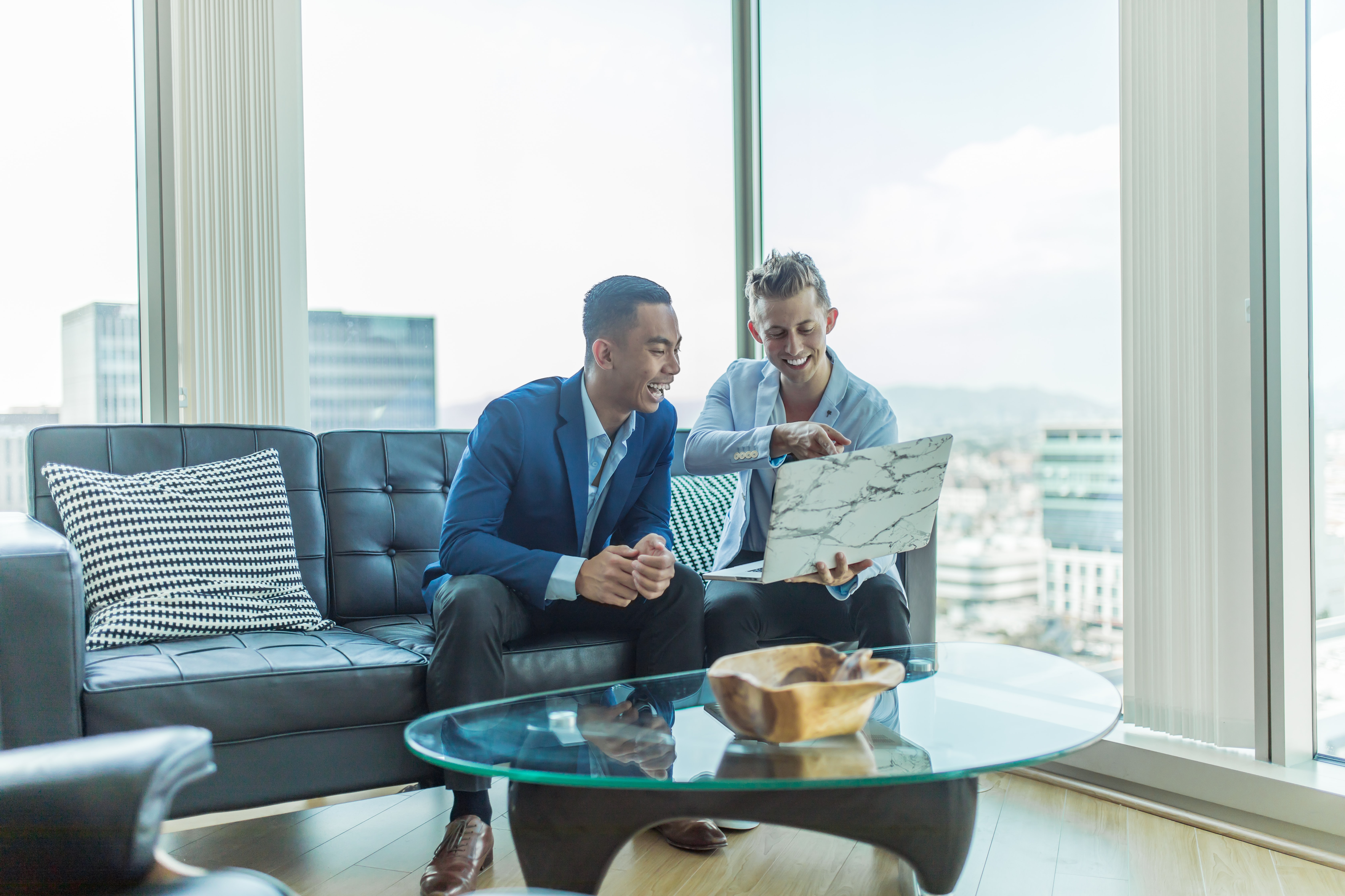 Two property professionals looking at a laptop